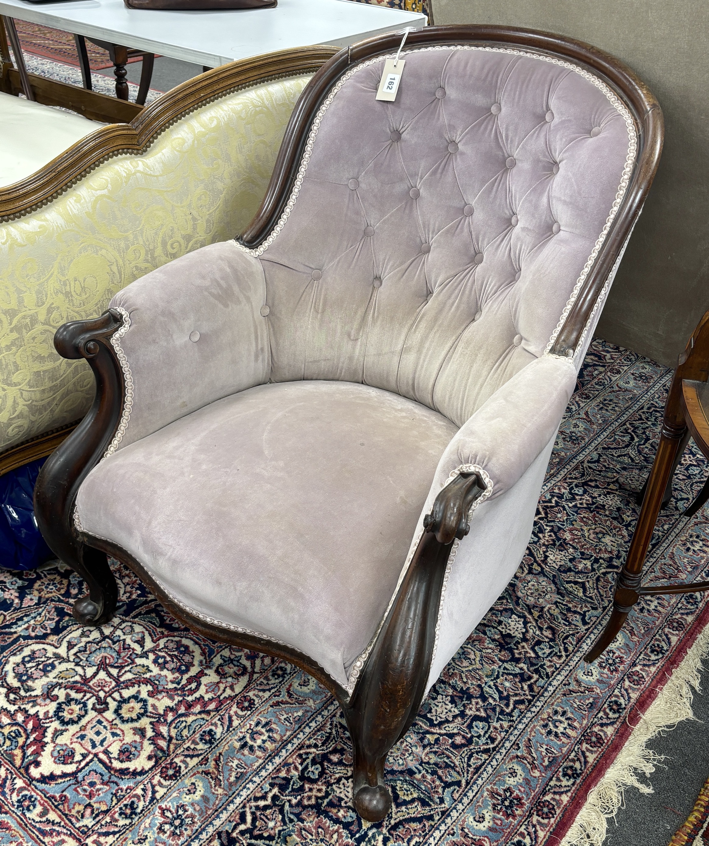A Victorian mahogany spoonback upholstered armchair, width 70cm, depth 86cm, height 88cm